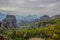 picturesque rocky highland landscape cloudy scenic view with focus on green trees foliage foreshortening from above Greece south