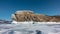 Picturesque rocky island on a frozen lake.