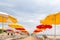 Picturesque rows of yellow and red umbrellas on an empty beach, Anapa, Russia