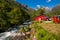 Picturesque scene of Urke village and Hjorundfjorden fjord, Norway. Drammatic sky and gloomy mountains. Landscape