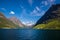 Picturesque scene of Urke village and Hjorundfjorden fjord, Norway. Drammatic sky and gloomy mountains. Landscape