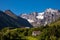 Picturesque scene of Urke village and Hjorundfjorden fjord, Norway. Drammatic sky and gloomy mountains. Landscape