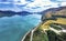 Picturesque scenic drive on winding road from Queenstown to Glenorchy by the Lake Wakatipu on a sunny day