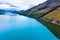 Picturesque scenic drive on winding road from Queenstown to Glenorchy by the Lake Wakatipu on a sunny day