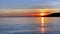 Picturesque seascape with amazing fiery sunset, panoramic view from shore. Golden sun rays break through clouds over the