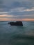 Picturesque seascape. Amazing landscape. Rock in the ocean. Motion waves. Silky water. Long exposure image. Soft focus. Concept of