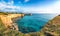 Picturesque seascape with white rocky cliffs, sea bay, islets and faraglioni near by beach Spiaggia della Punticeddha