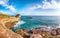 Picturesque seascape with white rocky cliffs, sea bay, islets and faraglioni near by beach Spiaggia della Punticeddha