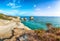 Picturesque seascape with white rocky cliffs, sea bay, islets and faraglioni near by beach Spiaggia della Punticeddha