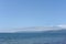 Picturesque seashore with beach and ocean waves and horizon on a sunny day with clear blue sky and calm ocean in Hokkaido, Japan