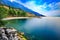 Picturesque shoreline of Lake Garda with green mountains. Italy.