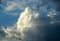 Picturesque sky with thunderstorms cumulus clouds. Blue sky with big clouds, backlit by sun. Air clouds background. Copy space.