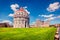 Picturesque spring view of famous Leaning Tower in Pisa. Sunny morning scene with hundreds of tourists in Piazza dei Miracoli