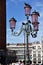 Picturesque street lamp with doves near the Doge`s Palace at the Piazza San Marco