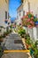 Picturesque street of Mijas with flower pots in facades. Andalusian white village. Costa del Sol. Southern Spain