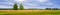 Picturesque summer landscape with beveled meadow and haystacks in cloudy morning. Hay harvest at farmland. Beautiful agricultural