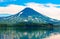 Picturesque summer reflection of Ilyinsky volcano in the Kurile lake water. South Kamchatka Sanctuary, Russia