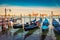 Picturesque summer view of the gondolas parked beside the Riva degli Schiavoni in Venice, Italy, Europe. Splendid Mediterranean sc