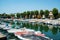 Picturesque summer view of the pier with ancient and modern buildings, yachts and other boats in Rimini, Italy - June 21, 2017