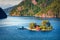 Picturesque summer view with small island with typical Norwegian building on Lovrafjorden flord, North sea. Colorful morning view