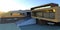 Picturesque sunrise in the mountains. Modern project of a country house. Sunlight on the facade. 3d render