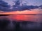 Picturesque sunset illuminating a tranquil beach scene, with boats in the calm, shimmering waters