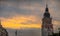 Picturesque tower on Rynek Glowny or main city square in Krakow on a sunny summer evening. Visible majestic sky behind the tower