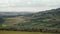 Picturesque Tuscany rural landscape with green hills, cypress trees, vineyards