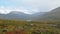 Picturesque valley between icelandic mountains, autumn, rain drops is falling on a camera lens