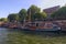 A picturesque view of the embankment of Seine River with residential vintage barges. Sunny spring day