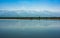 Picturesque view of the Fagaras mountain range mirrored in water of artificial lake, Transylvania, Romania