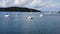 Picturesque view of an idyllic island landscape with several sailboats moored