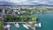 Picturesque view of Lausanne city on shore of Lake Geneva on background of mountains on summer day, Switzerland