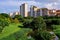 Picturesque view of local colourful public housing in setting of lush greenery, on bright sunny day