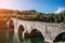 Picturesque view of medieval stone arch bridge Ponte della Maddalena across river Serchio in Borgo a Mozzano, Lucca, Tuscany,