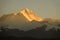 Picturesque view of orange hued evening sunbeams illuminating Mount Everest.