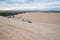 Picturesque view of parked motorbike on sandy dunes in desert.