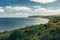 Picturesque view of rocky promontory that goes to sea on a beautiful sunny day