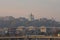 Picturesque view of St. Andrew`s Church at the hill and one of the oldest district in Kyiv-Podil during autumn sunrise