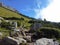 A picturesque view of stone boulders scattered on the rocky mountain slopes of the rocks against the background of the blue sky