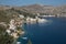 Picturesque view of a tranquil town nestled on the shore of the sea in Symi island, Greece.