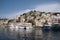 Picturesque view of a tranquil town nestled on the shore of the sea in Symi island, Greece.