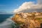 Picturesque village Azenhas do Mar. Holiday white houses on the edge of a cliff with a beach and swimming pool below. Landmark nea