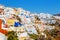 Picturesque village and the rest in the traditional white houses in Oia, Santorini, Greece