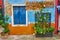 Picturesque walls with windows and door with shutters at the famous island Burano, Venice