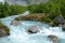 Picturesque water stream with water melted from Jostedalsbreen Glaciern Sogn og Fjordane county, Norway.