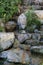 Picturesque waterfall cascading over rugged boulders and lush ferns