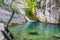 A picturesque waterfall in a cozy mountain lagoon.