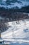 Picturesque winter landscape with footprints on snow covering the mountain slope