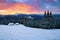 Picturesque winter landscape with huts, snowy mountains.